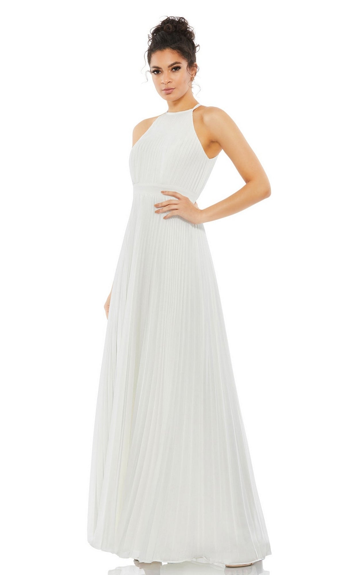 A woman poses confidently with one hand on her hip, wearing the Long Formal Dress 12496 by Mac Duggal—a sleeveless, white pleated gown with a high neckline—against a white background.